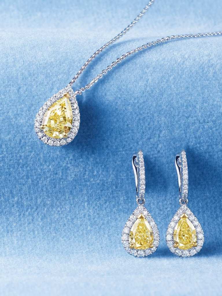 Classics Jewellery Collection white gold Necklace and Earrings with yellow diamond on blue background