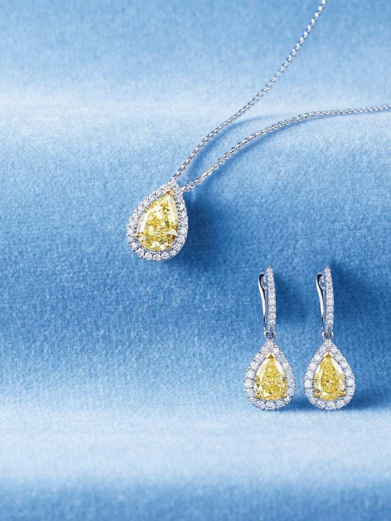 Classics Jewellery Collection white gold Necklace and Earrings with yellow diamond on blue background