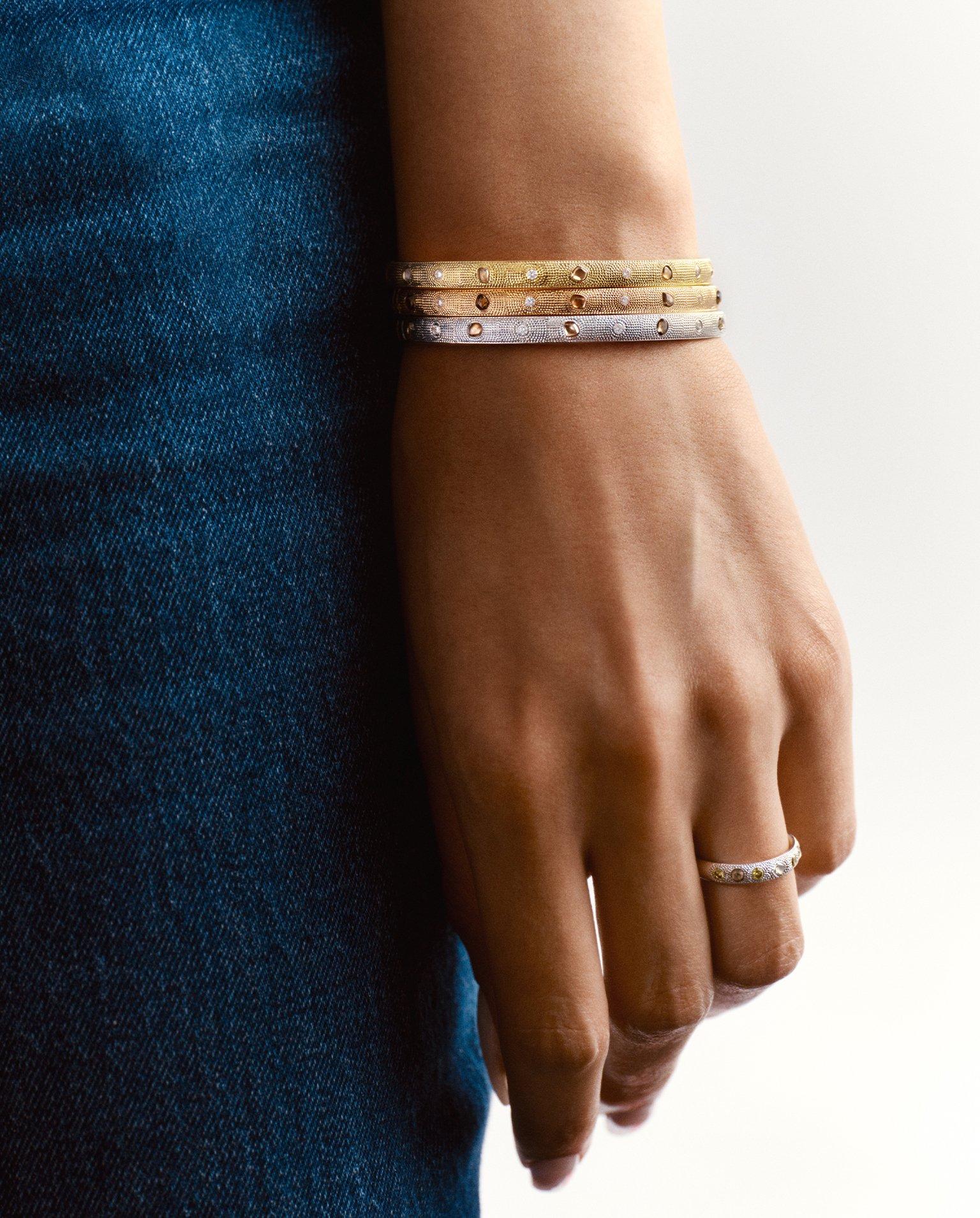 Lotus on model wearing Lotus by DE BEERS jewellery collection